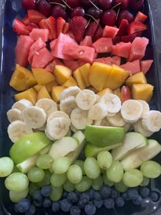 fruit tray with grapes, watermelon, bananas, strawberries and kiwis