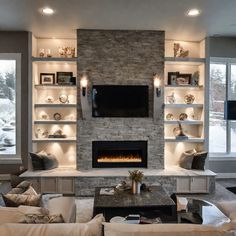 a living room filled with furniture and a fire place in front of a flat screen tv