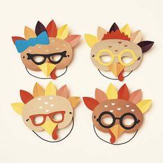 four masks with different designs on them, one is wearing glasses and the other has a bird's head