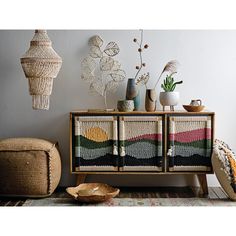 a crocheted cabinet with vases and other items on the shelf next to it