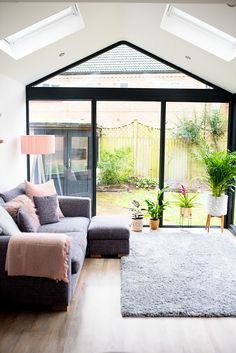 a living room filled with furniture and a large glass door that leads to a patio