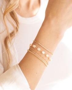 Elevate your outfit with the Lily Bracelet. This chunky pearl bracelet is a must-have addition to any fun and chic outfit. With an extender for easy wearing, it is one of our favorites. Stacked here with our Chloe Bracelet, Camilla Bracelet, and our Devon Bracelet. The sister to this is our Lily Necklace! Details: - Gold Filled - 2" extender Pearl Chain Bracelets, Chic Adjustable Pearl Bracelet With Pearl Charm, Chic Adjustable Pearl Bracelet With Charm, Chic Adjustable Pearl Bracelet, Party Pearl Drop Beaded Bracelets, Chic Adjustable Bracelet With Pearl Charm, Chic Adjustable Bracelets With Pearl Charm, Chic Pearl Charm Bracelet As Gift, Chic Pearl Charm Bracelets As Gifts