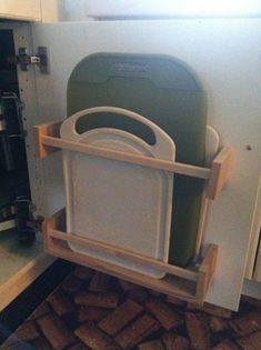 two green chairs are stacked on top of each other in front of a refrigerator door