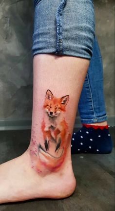 a woman's foot with a small tattoo of a fox on the side of her leg