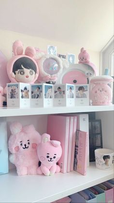 there are many pink items on the shelves in this room, including stuffed animals and books