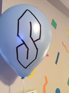 a blue balloon with the number three drawn on it