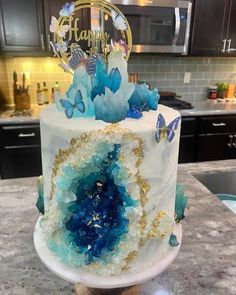 a white cake with blue and gold decorations