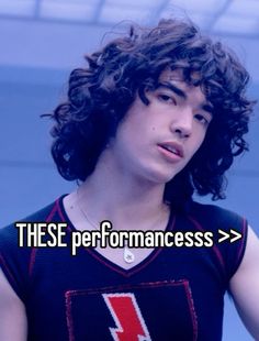 a young man with curly hair wearing a shirt that says, these performanceess > >