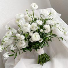 a bouquet of white flowers sitting on top of a table