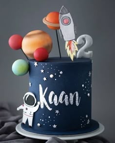 a birthday cake with an outer space theme and rocket ship on the top that says kaan