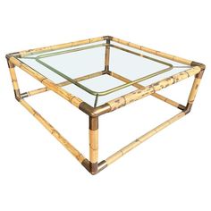 a glass and bamboo coffee table on white background