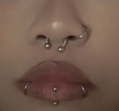 a woman's nose with piercings on it