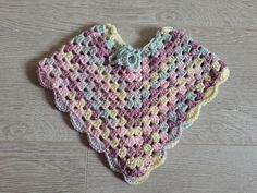 a crocheted heart hanging on the floor