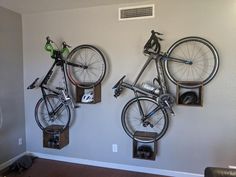 two bikes are mounted to the wall in this living room, one is upside down