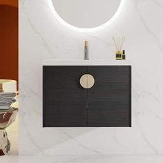 a bathroom vanity with a round mirror above it and a white marble wall behind it