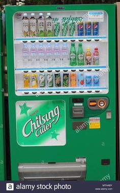 a green vending machine with drinks and sodas in it's display case