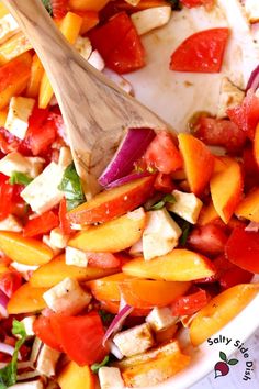 a bowl filled with chopped up vegetables and a wooden spoon on top of the bowl