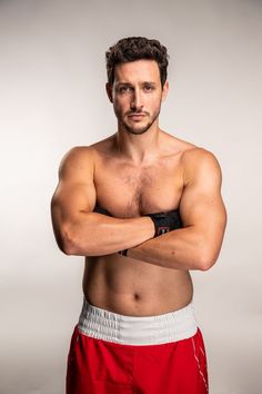 a shirtless man with his arms crossed