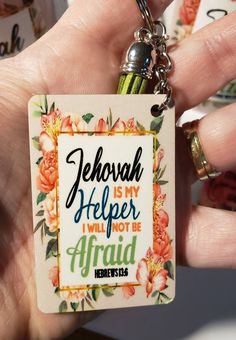 a hand holding a keychain that says jehovah is my help i will not be afraid