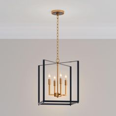 a chandelier hanging from the ceiling with four candles in it and one light on each side