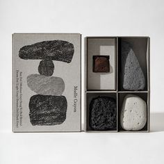 four different types of rocks in a box