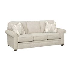 a white couch with two pillows on it