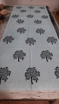 a white table with black trees on it