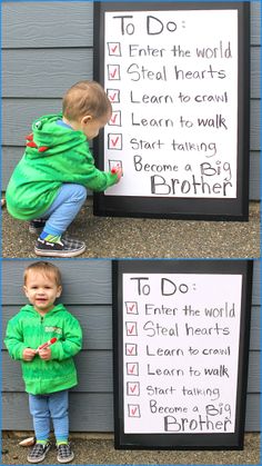 a little boy in green jacket standing next to a sign with words written on it