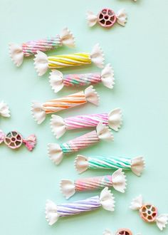 colorful candy lollipops are lined up on a blue surface