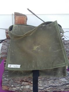 "This is a traditional haversack make with waxed OD green canvas. It's aprox. 12\"X12\" with a 60\" strap. This bag is great for around town trips as well as a multi-day trip into the bush. The canvas has been permeated with wax at the fabric mill so it is completely infused. This ensures that the bag will be water resistant and rugged enough for any adventure for years to come. comes with a 1\" fastex style closure to ensure the flap stays closed and tight. Waxed canvas has a long lifespan beha Military Style Durable Bag For Everyday Use, Durable Military Style Bag For Everyday Use, Durable Green Shoulder Bag For Outdoor, Green Durable Shoulder Bag For Outdoor, Outdoor Durable Green Shoulder Bag, Durable Khaki Shoulder Bag For Everyday Use, Waxed Canvas Backpack Shoulder Bag For Outdoor, Green Outdoor Shoulder Satchel, Green Crossbody Satchel For Outdoor