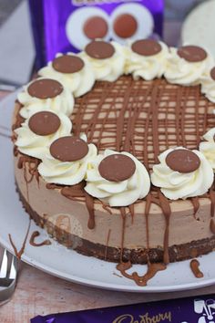 there is a chocolate cake with white frosting on the plate next to some candy