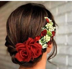 a woman with flowers in her hair wearing a red and white flowered headpiece