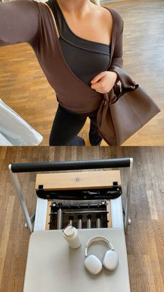 a woman standing in front of an old typewriter with headphones on her ears