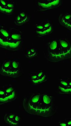 glowing jack o lantern pumpkins glow in the dark with green eyes and mouth shapes