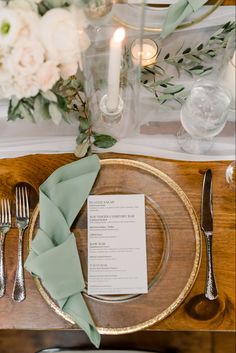 a place setting with silverware and napkins