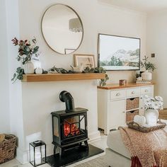 a living room filled with furniture and a fire place next to a mirror on the wall