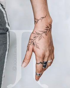 a person's hand with a tattoo on it and a ring in the middle