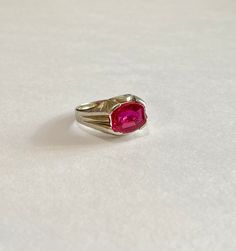 Awesome vintage 10k white gold 1930s era ring featuring a vibrant created ruby! The deep red / pink gem weighs an estimated 3.79 carats, is emerald cut, and securely bezel set. The substantial setting is detailed with decorative designs on the shoulders. Charming vintage piece of fine jewelry for him or her, featuring July's birthstone! ERA - Circa 1930 METAL / MATERIAL - 10k white gold, 1 created ruby (estimated 3.79 carats) [Synthetic ruby contains essentially the same chemical composition &am Classic Pink Ruby Rings, Classic Red Gemstone Signet Ring, Classic Emerald-cut Pink Ruby Ring, Heirloom Style Solitaire Ruby Ring, Classic Pink Lab-created Ruby Ring, Classic Red Ruby Signet Ring, Vintage Oval Ruby Ring With Lab-created Ruby, Vintage Red Oval Birthstone Ring, Vintage Oval Lab-created Ruby Ring