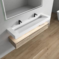 two white sinks sitting on top of a wooden counter next to a mirror above them