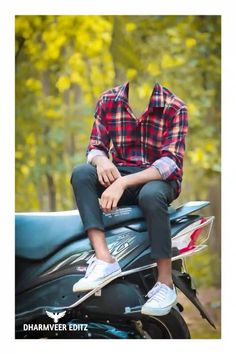 a man sitting on top of a motorcycle in front of some trees and bushes with his legs crossed