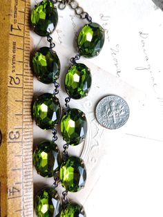 "Lovely green olivine oval stones are like a ring of crystallized mossy green forest around your neck. Each stone hand set and hand linked with high quality findings. Made to last a lifetime. Adjustable from 16 to 18\" with lobster claw and extender. stones are 18x13mm Beautiful for layering. Inspired by georgian collets. Gift boxed Find more to layer here : Www.sacredcake.etsy.com" Green Oval Jeweled Jewelry, Green Oval Jewelry For Party, Elegant Green Oval Beads Jewelry, Vintage Green Crystal Jewelry, Green Crystal Necklace With Stones, Green Oval Pendant For Jewelry Making, Elegant Green Oval Bead Necklaces, Elegant Green Necklaces With Oval Beads, Elegant Green Oval Beaded Necklaces