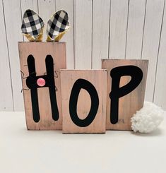 two wooden blocks with the word hop painted on them