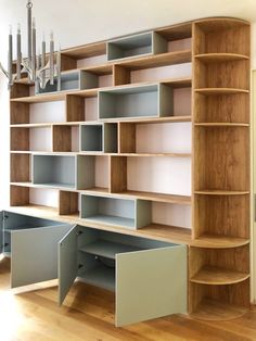 a book shelf with several shelves in it and a chandelier hanging from the ceiling