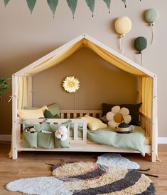 a child's bedroom with a tent bed and rugs