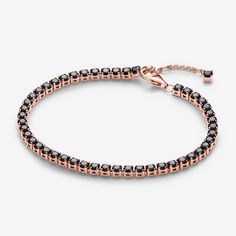 Add boldness to your look with the Black Sparkling Tennis Bracelet. Plated with 14k rose gold, it showcases 48 prong-set black man-made crystals in squared open baskets. The adjustable closure with a dangling stone offers a personalized fit. Ideal for stacking with various colours and metals, this bracelet introduces a bold black stone to Pandora's Timeless collection. Experience the elegance of repetition and contrast, adding depth to your bracelet stack. - Pandora Black Sparkling Tennis Bracelet - 14k Rose gold-plated unique metal blend / Man-made crystal / Black - Sz. 7.9 in Elegant Rose Gold Jewelry With Black Diamonds, Formal Rose Gold Jewelry With Black Diamonds, Rose Gold Jewelry With Black Diamonds, Pandora Black, Black Man, Bold Black, Black Stone, Lab Created Diamonds, Tennis Bracelet