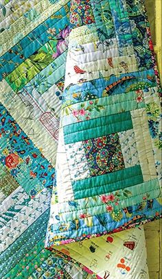 several quilts are stacked on top of each other