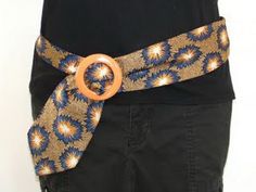 a person wearing a black shirt with a blue and gold tie on it's belt