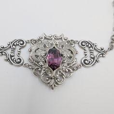 This unique Amethyst bracelet is made with sterling silver plated brass vintage stampings that form a gothic/fantasy look. The center 16x11mm stone is a vintage Swarovski crystal (no longer in production). The bracelet measures 2" tall and 7.5" long, which will fit most women's wrists. I offer two options for the closure:1. A steel slider chain that is easy to adjust and secure.2. A sterling silver plated brass cable chain with a lobster claw closure. If you need longer chain, then please let me Fantasy Bracelet, Fantasy Look, Jewelry Gothic, Vintage Gothic, Amethyst Bracelet, Bracelet Vintage, Gothic Jewelry, Amethyst Crystal, Cable Chain