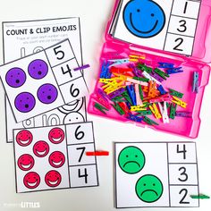 two pink trays filled with different colored numbers and smiley faces next to each other