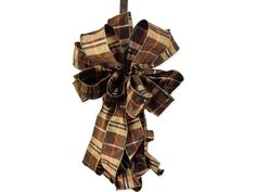 a brown and tan plaid bow hanging from a hook